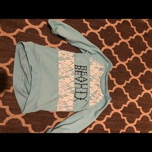 A light blue children’s shirt with lace